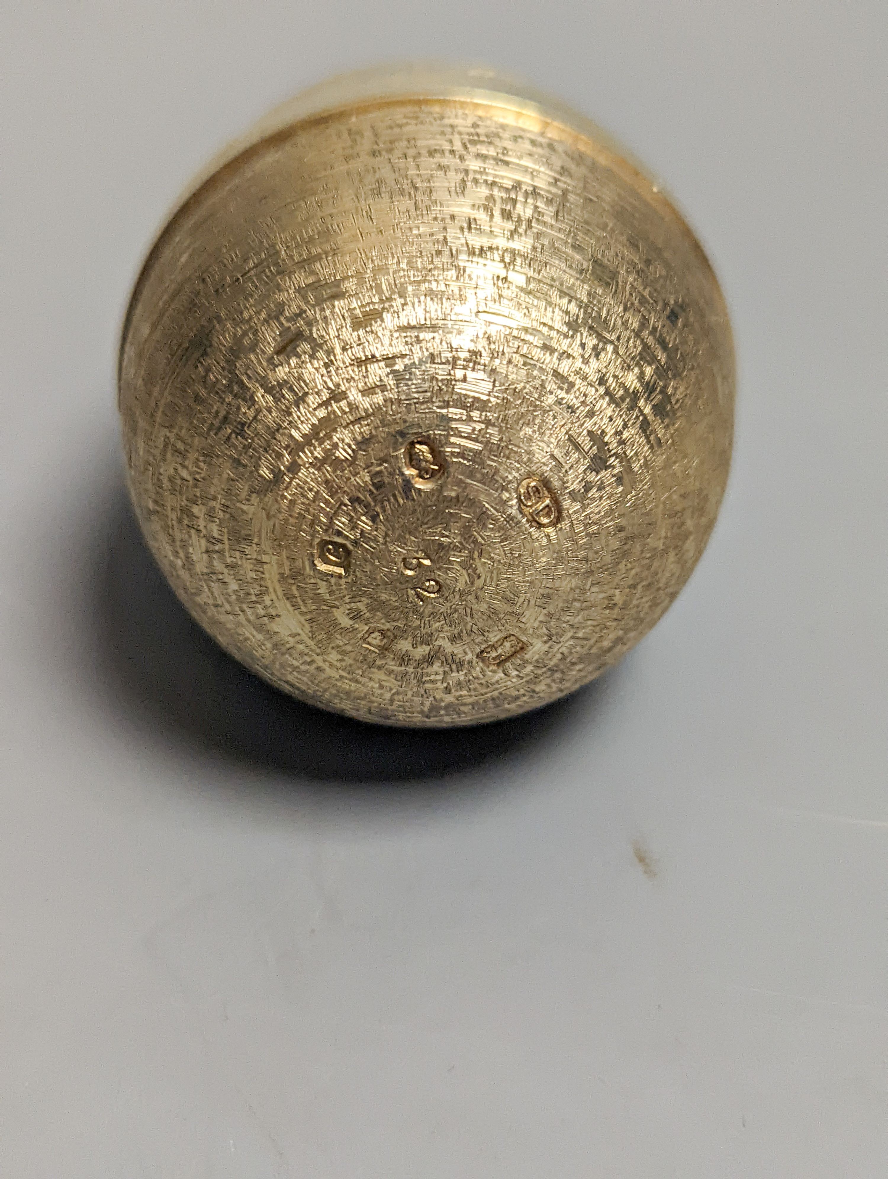 A 1970's textured silver gilt surprise egg by Stuart Devlin, opening to reveal a ship's anchor with fish, London, 1977, 71mm, no box or certificate.